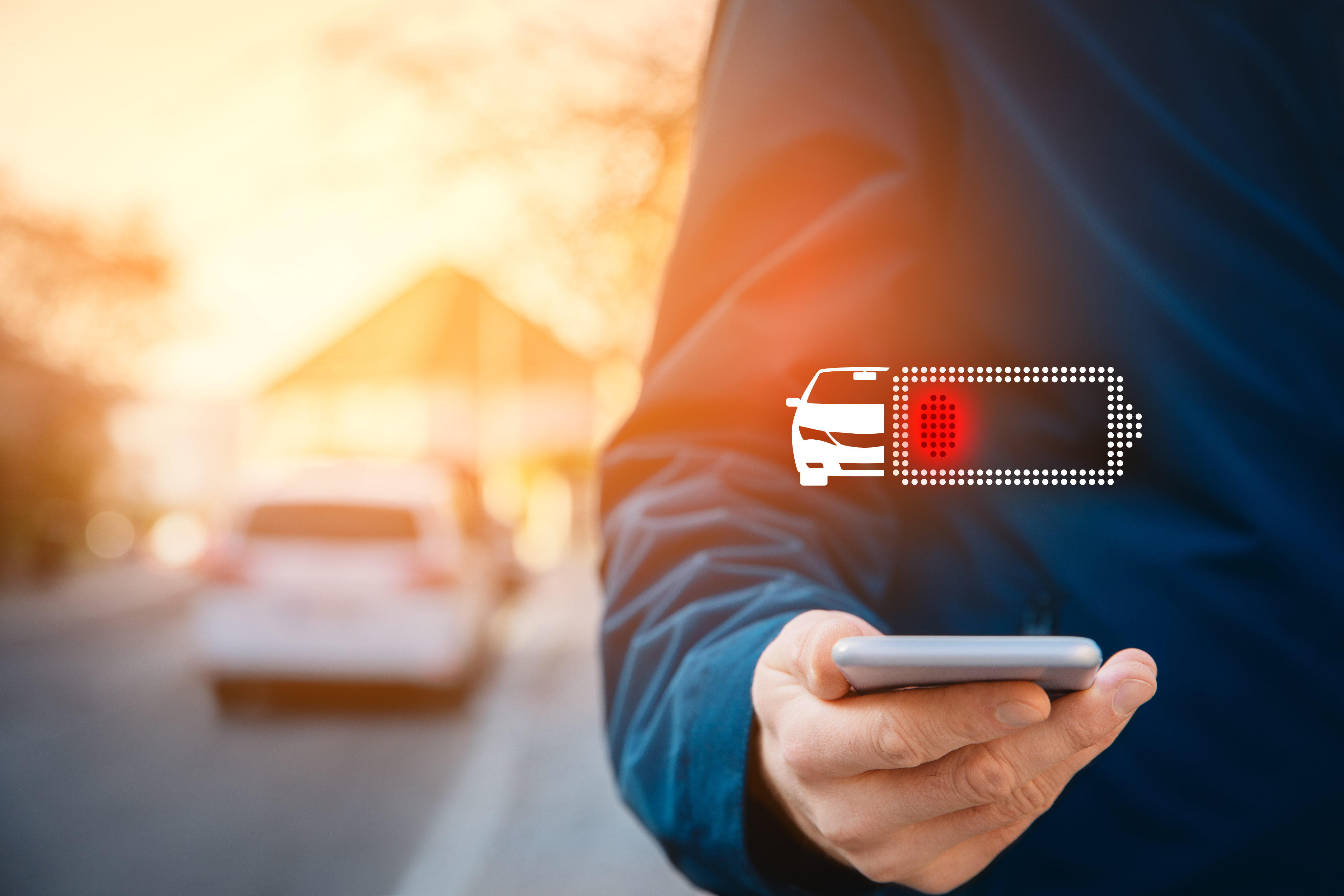 Phone in hand indicating flat EV battery
